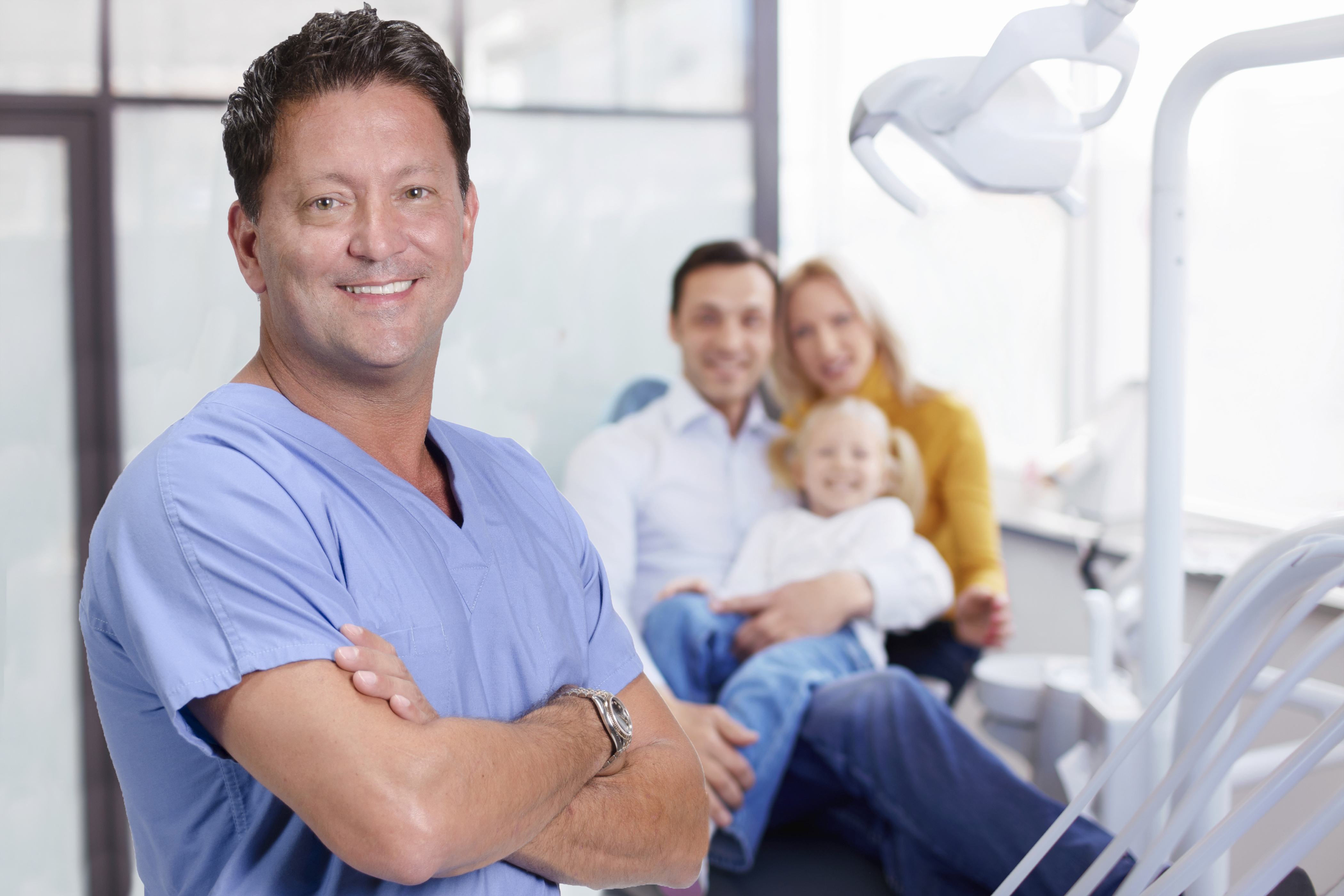 A Smiling Dentist With His Clients | Emergency Dental Center | Aegis Dental Group or Angola Dental Center