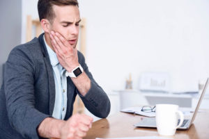 A Man Experiencing Jaw Pain | Emergency Dental Center | Aegis Dental Group or Angola Dental Center