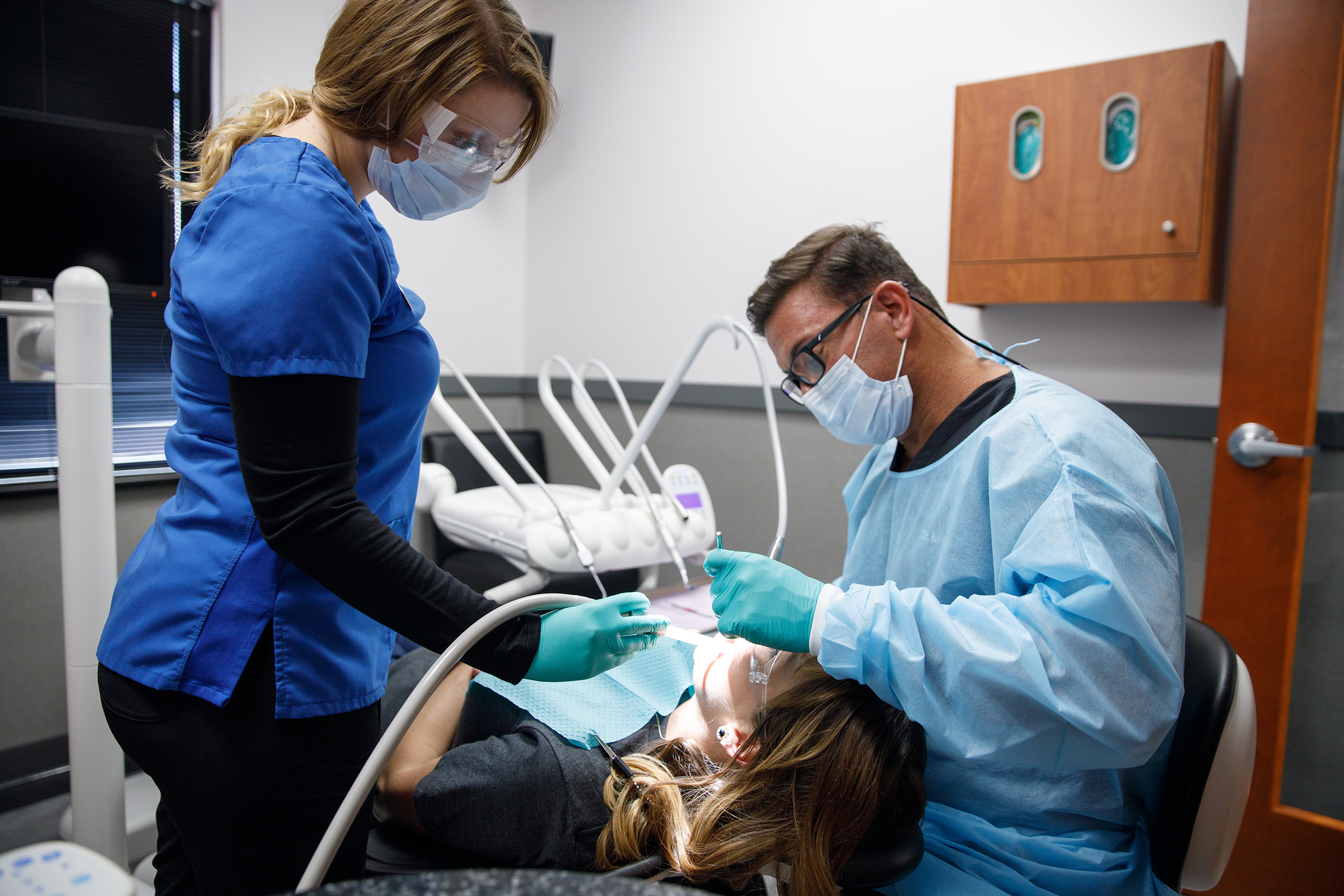 Aegis Dental Group or Angola Dental Center | Dentist Treating a Patient
