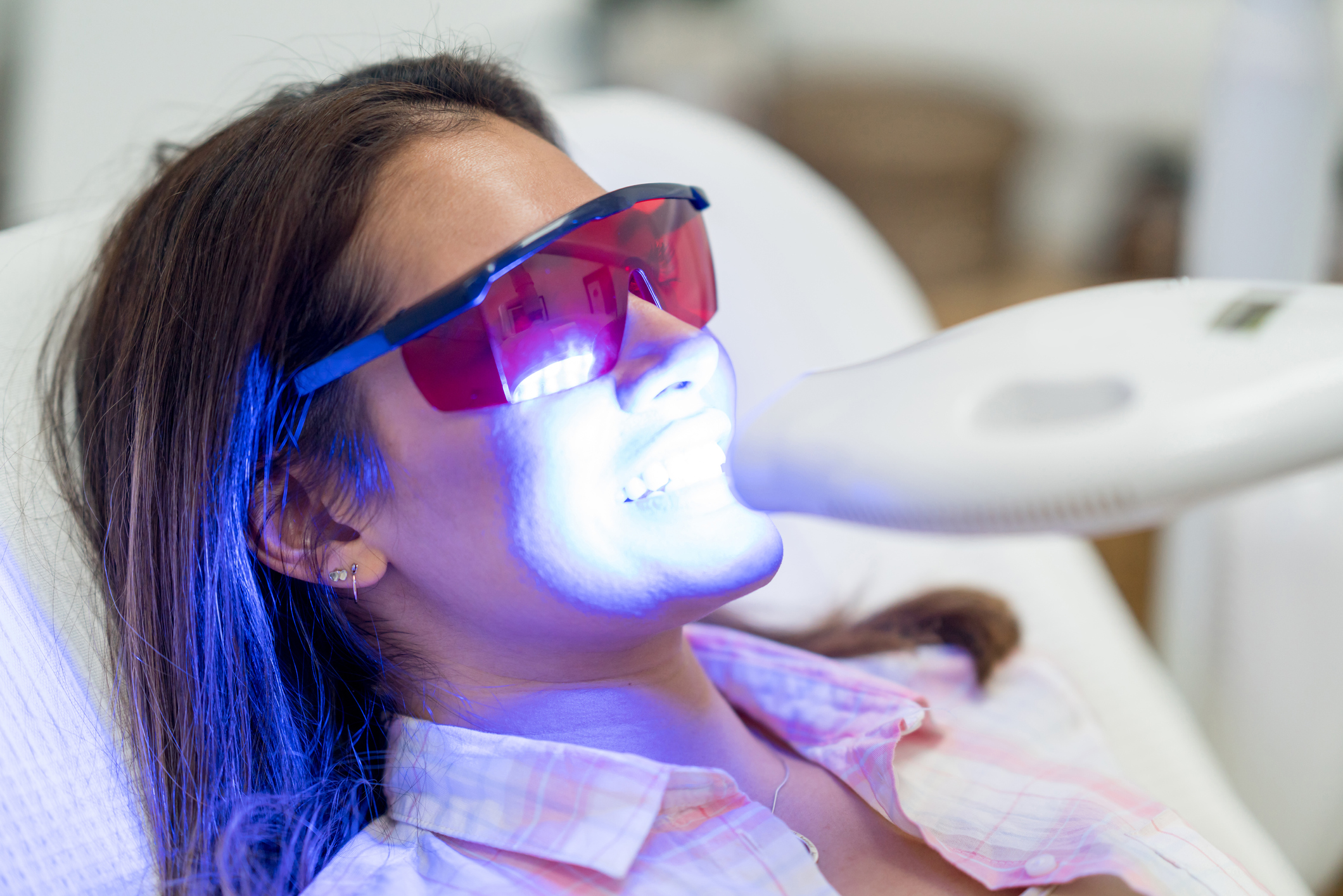 A Woman Getting Laser Whitening Treatment | Teeth Whitening Indiana | Aegis Dental Group or Angola Dental Center